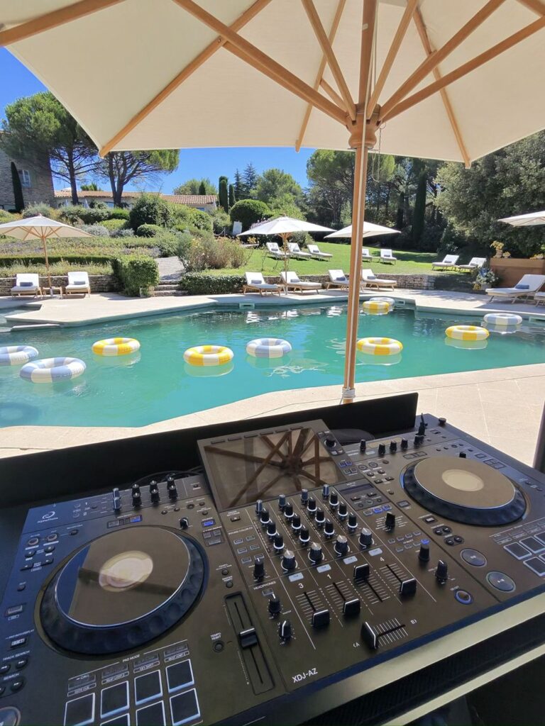 DJ decks facing the pool at Capelongue for a wedding pool party, Bonnieux